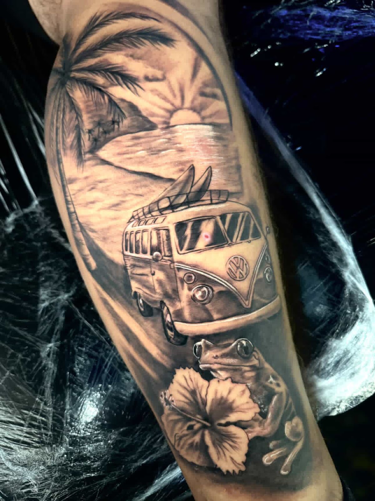 Detailed VW van beach scene leg sleeve tattoo