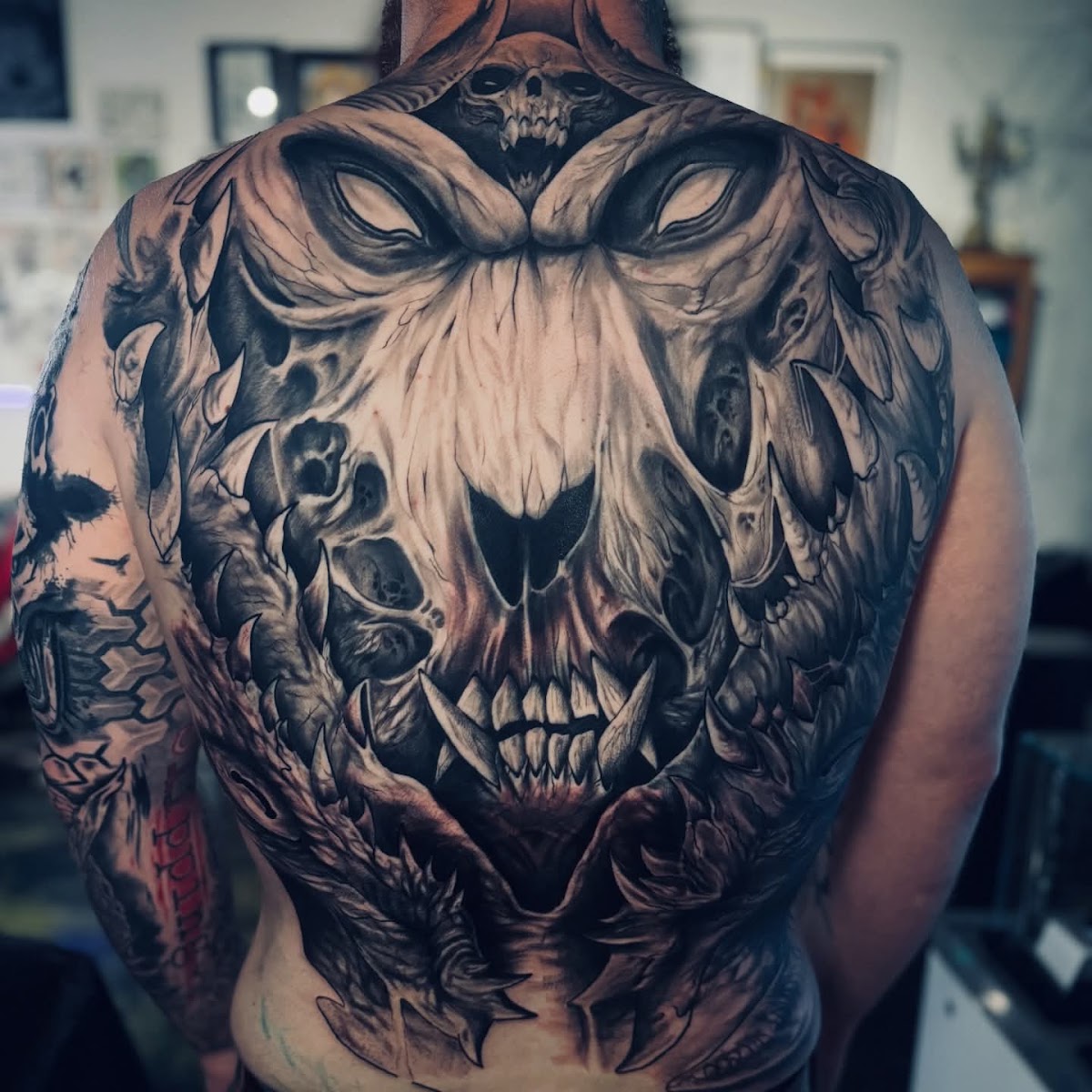 Massive full back skull realism tattoo in black and grey